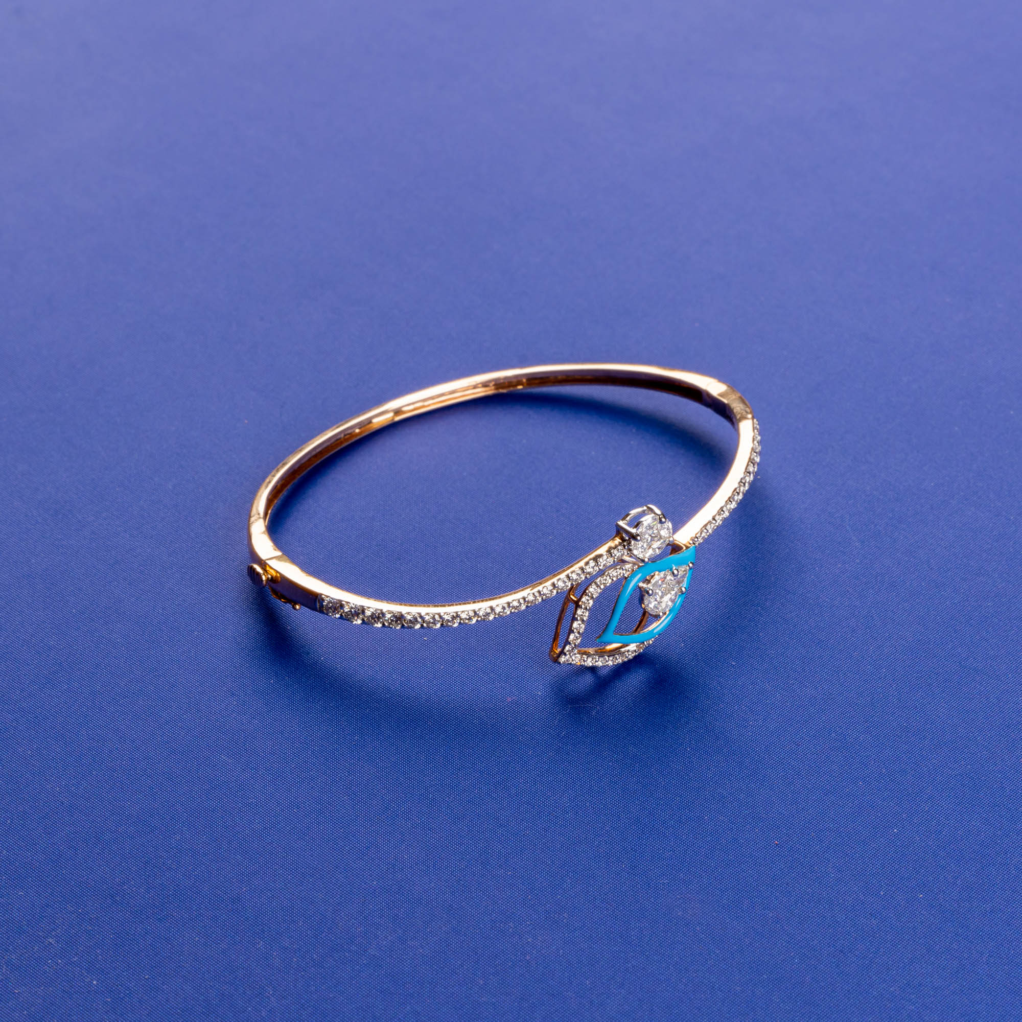 Enigmatic Gaze: Handmade 18K Rose Gold Diamond Bangle with Alluring Eye-shaped Design and Subtle Blue Accents