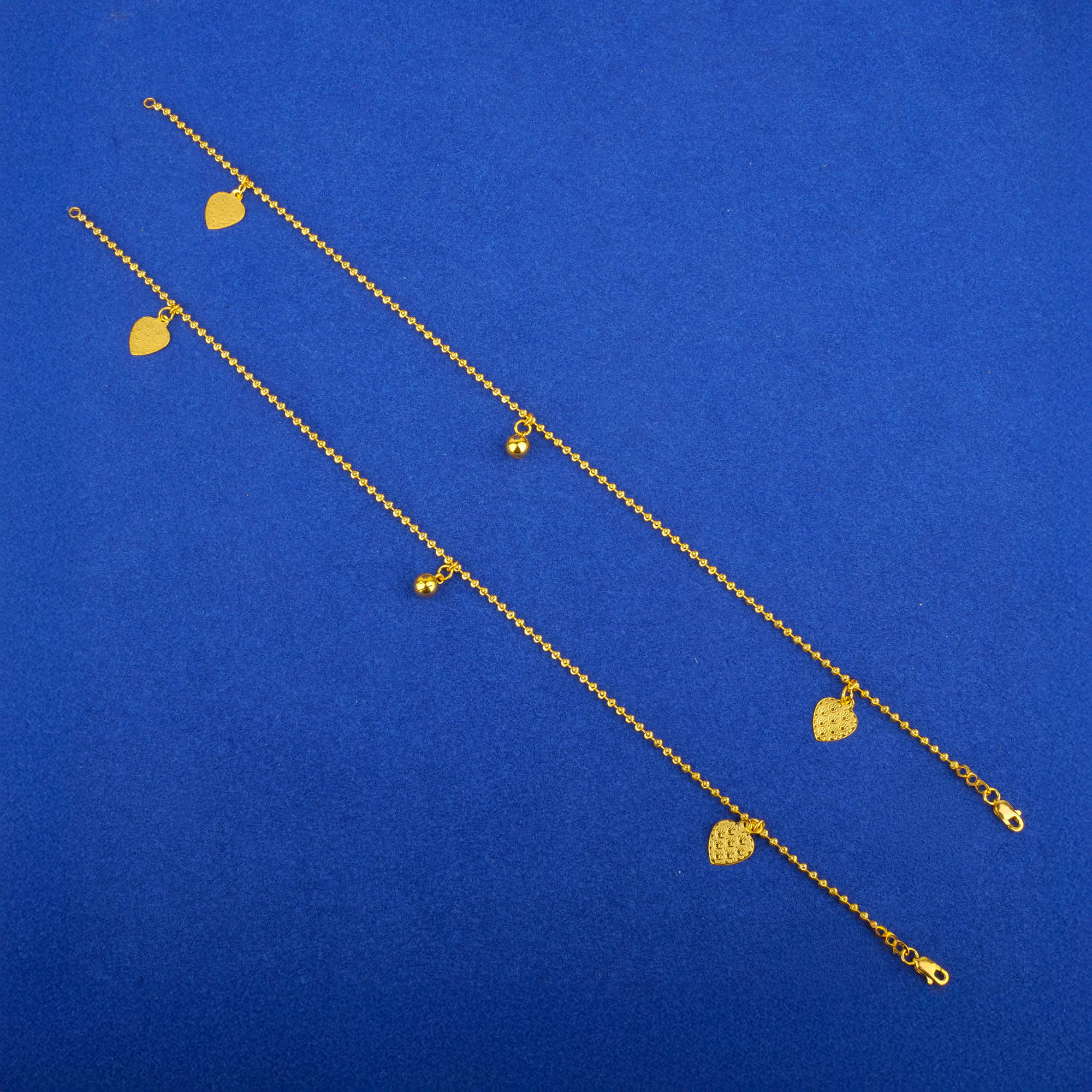 Twenty-Two Karat Gold 'Charm' Anklets (Pair)