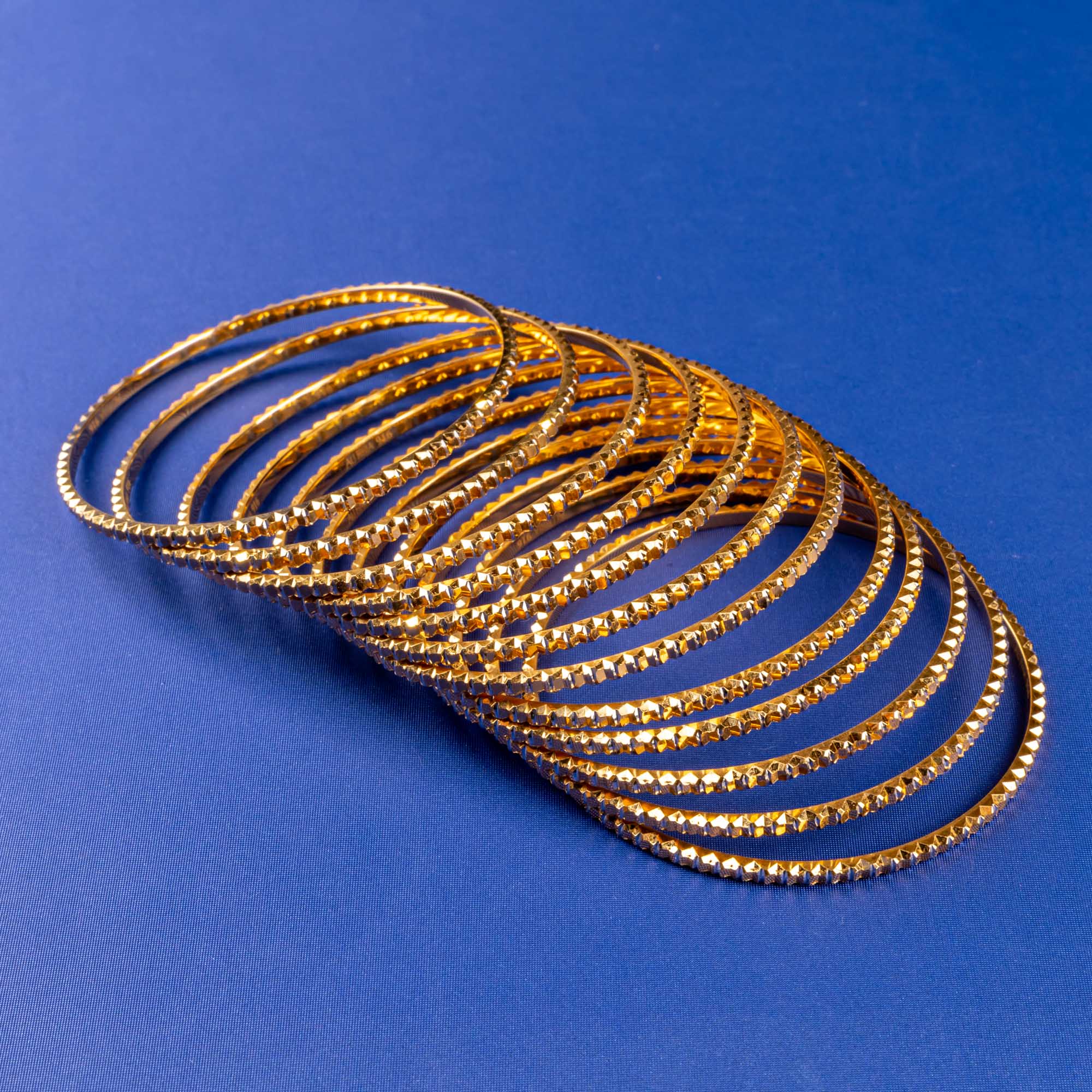 Enchanting Dozen: Artisan-crafted Set of 12 22K Two-Tone Gold Bangles