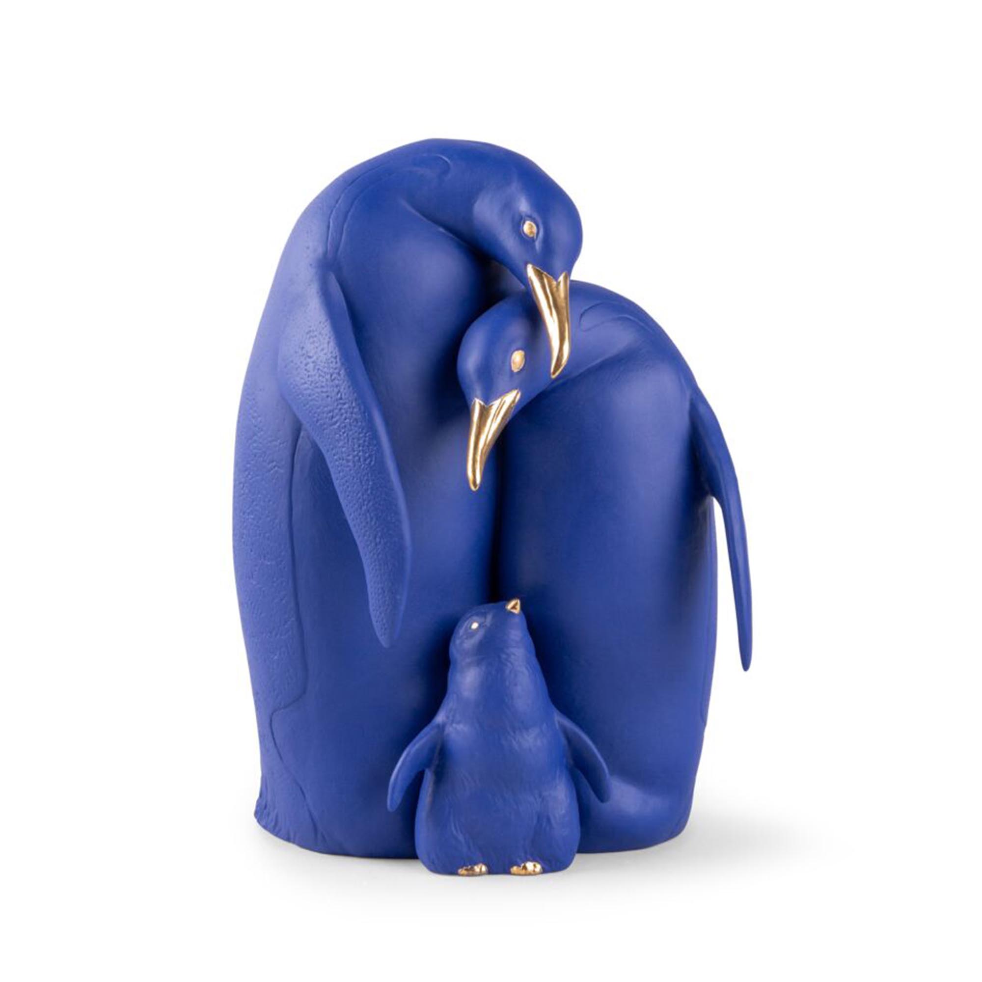 This Limited Edition Lladro Penguin Family features a vibrant electric blue matte porcelain with golden luster.