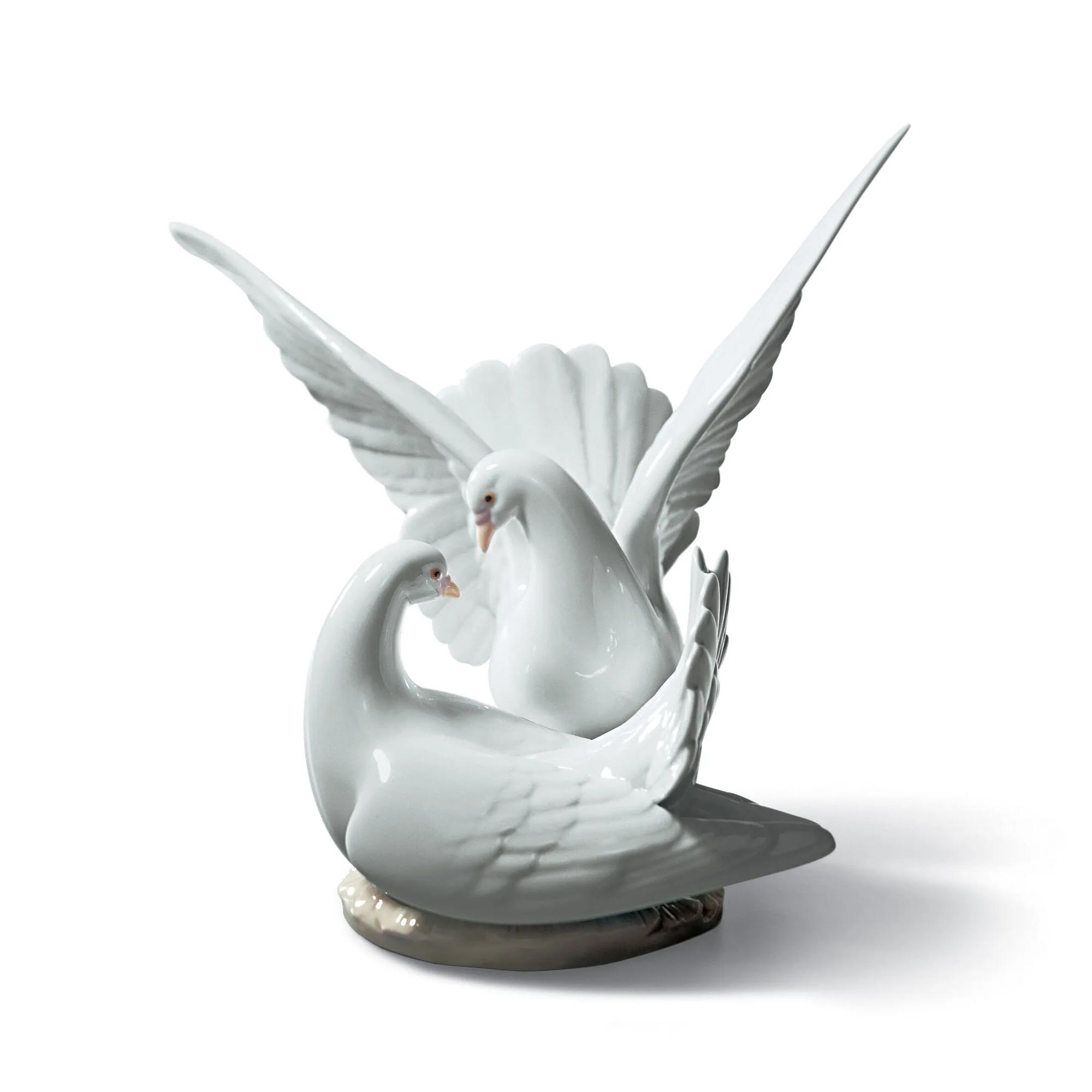 Love Nest Doves Figurine of two white porcelain pigeons, one of them with its wings open.